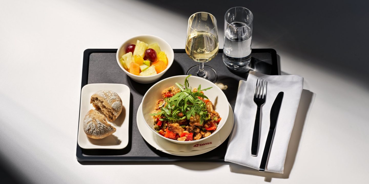 A tray featuring pasta, mixed vegetables, and a piece of bread, representing a special meal.