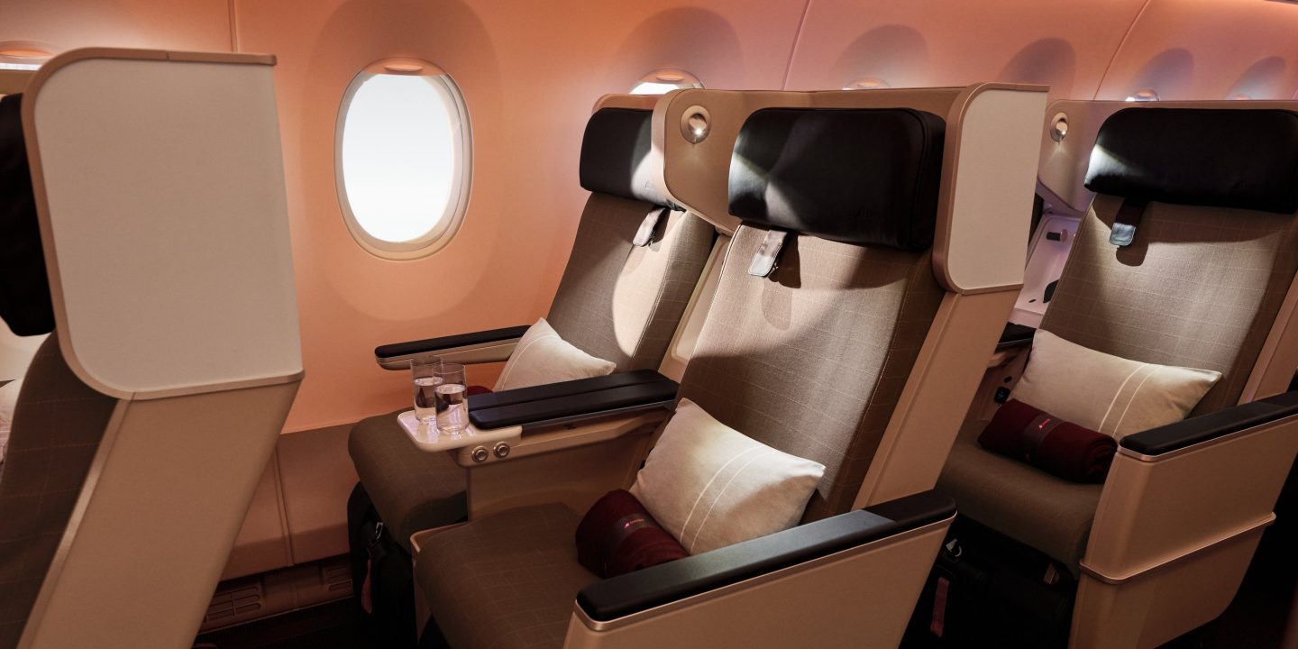 Spacious airplane seats with plush cushions and soft lighting.