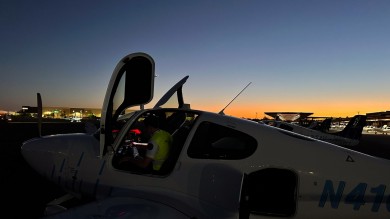 Cirrus SR20 aircraft are waiting on the large apron early in the morning.