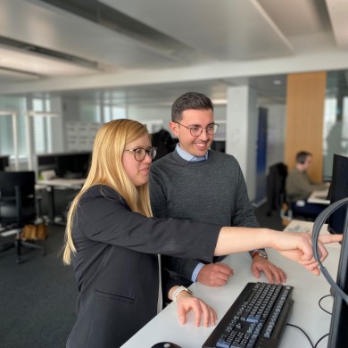 Katrin and Francesco at SWISS headquarter looking in a computer