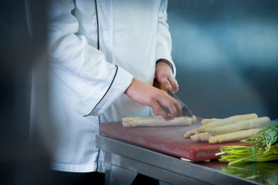 An chef cuts aspargus
