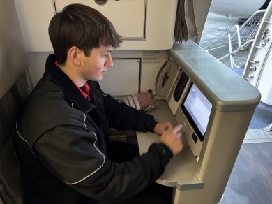 Sinan at a screen inside the aircraft.