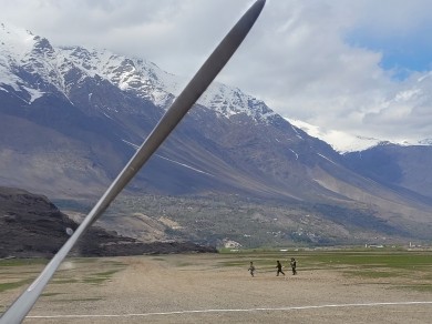 Mountain peaks rising above lush green valleys in Afghanistan.