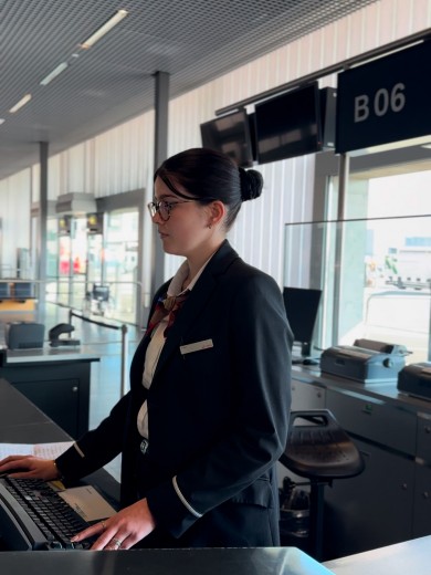 Gate Agent Sina Meni from Swissport welcomes passengers at the gate in Zurich.