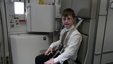 Vincent on the jump seat – ready for his adventure above the clouds.