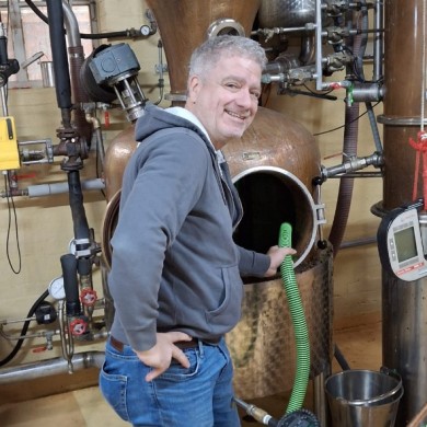 Hans lends a hand at the copper still — fully involved in the distillation process from start to finish.