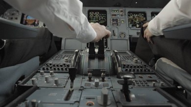 The hand of one of the pilots on the gas pedal