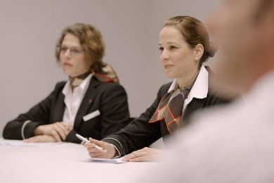 SWISS Cabin Crew listening and writing down information
