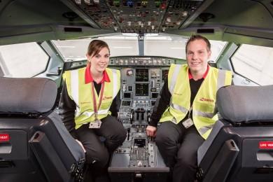 Two SWISS technics in the cockpit, smiling at camera