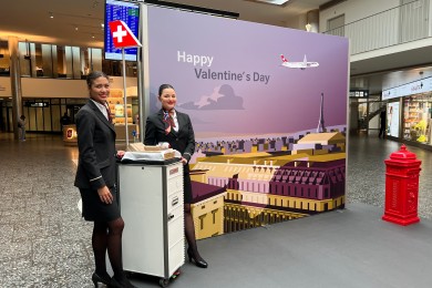 Two SWISS employees standing by the photobooth