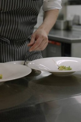 A Chef preparing two plates full of food