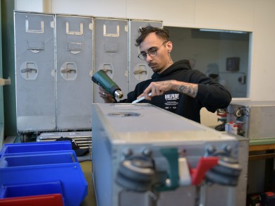 Francesco vom Züriwerk arbeitet konzentriert an der Restaurierung eines gebrauchten Trolleys.