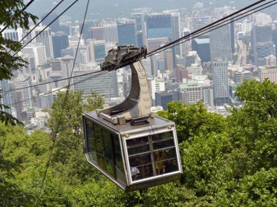 The cable car runs directly from the city over the treetops to Namsan Mountain.