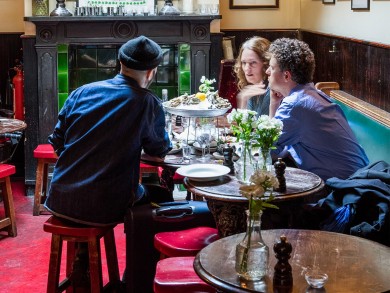 People sitting in the pub The Cow.