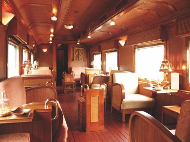 The elegant lounge car of the Eastern & Oriental Express provides a relaxed space for passengers to enjoy the passing scenery and spend time between excursions.