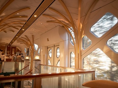 The elegant bar aboard the Shiki-Shima, offering passengers a refined setting to relax and enjoy a drink while traveling through Japan's scenic landscapes.