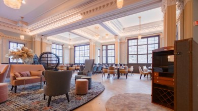 The Art Nouveau hall of Mürren Palace serves as a warm and inviting living room, where retro elegance meets contemporary comfort.
