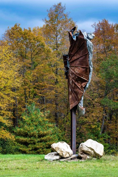 Southern Vermont Arts Center's sculpture park with a sculpture in the middle of the forest. 