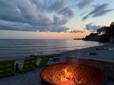At the evening bonfire on the shores of Lake Ontario, thoughts wander into the distance.
